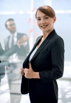 portrait of a young business woman on the background of the office.photo with copy space