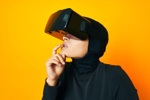 Muslim in black hijab VR glasses emotions studio lifestyle. High quality photo