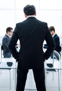 rear view.businessman standing in the conference room.business concept