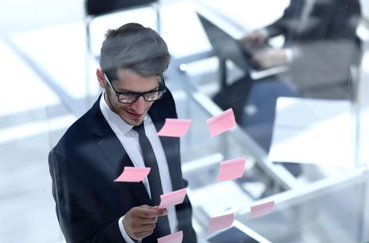 top view.businessman reading sticky notes on the glass.photo with copy space