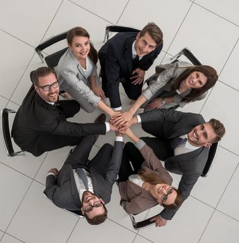 top view.business team sitting in a circle and looking at the camera