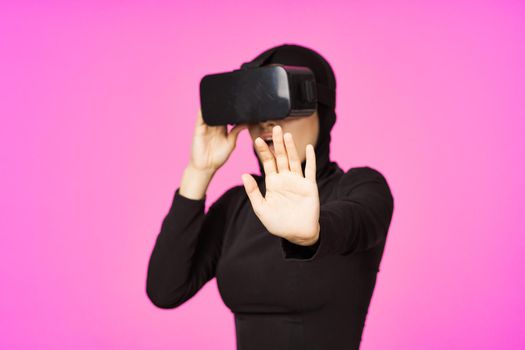 muslim woman wearing virtual reality glasses entertainment technology device. High quality photo