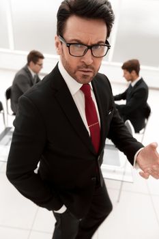 close up.serious boss standing in the conference room.business concept