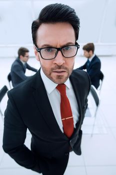 close up.serious businessman standing in the conference room.business concept