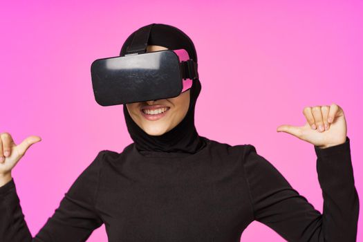 muslim woman wearing virtual reality glasses entertainment technology device. High quality photo