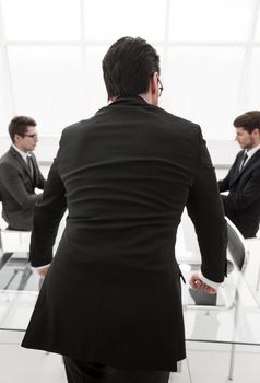 rear view.businessman standing in the conference room .business concept