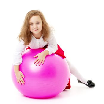 A good girl is playing with a big inflatable ball. The concept of a happy childhood, recreation in nature, exercise. Isolated on white background.