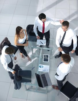 Portrait of smiling business people sitting at conference table in office