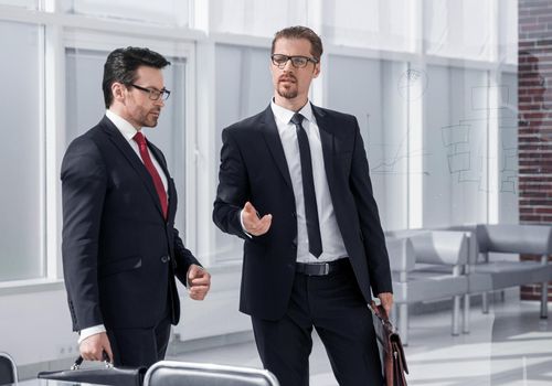 Business partners talking inside the building under construction