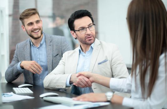 handshake business partners over the Desk. concept of partnership