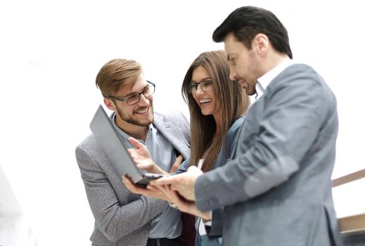 close up.employees with a laptop discussing new information . photo with copy space