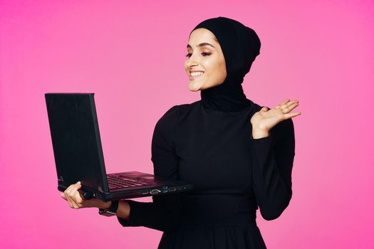 cheerful muslim woman with laptop education student internet technology. High quality photo