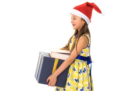 Beautiful little girl in a Santa Claus hat with a gift on a white background. The concept of Christmas, New Year's holidays. Isolated.