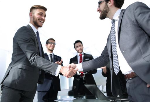 handshake business partners standing in the office.concept of partnership