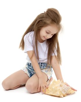 A little girl with a sea shell. The concept of a family vacation at sea, ecology. Isolated on white background.