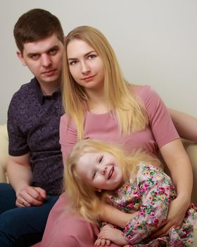 Happy family couple on a black background. Studio portrait.