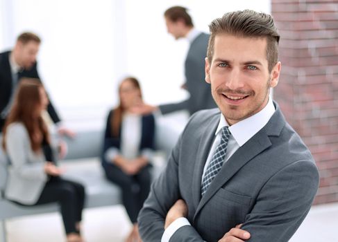 close-up of a successful businessman, against colleagues