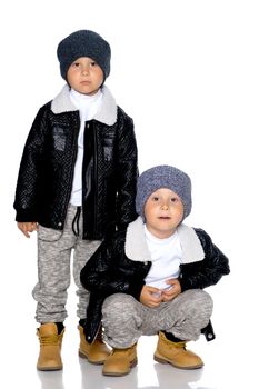 Studio portrait of boys in black leather jackets.Isolated on white background.