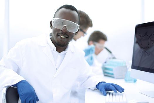 promising scientist on the background of the laboratory.photo with copy space