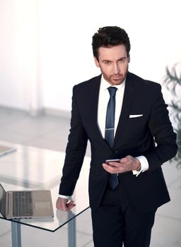 confident businessman standing in the office. the concept of communication