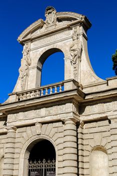 Old arch with sculpture in Rome, Italy. Concept of art and architecture of Europe.