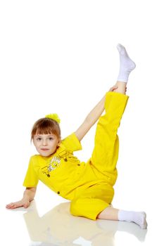 Girl with a short bangs on her head and bright yellow overalls.She crouched down on the white advertising banner.