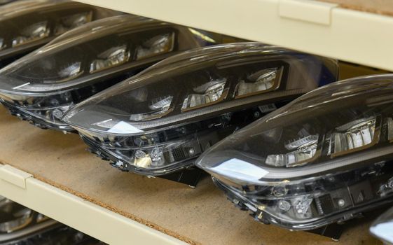 Row of the car headlights at the factory