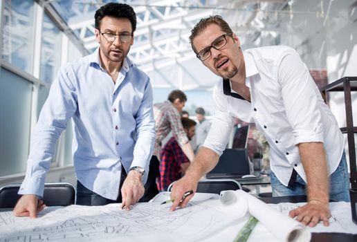 close up.professional designers standing at the workplace .the concept of professionalism