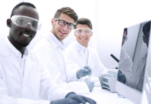 successful group of scientists sitting at their Desk.science and technology