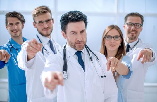 team of doctors and nurses, pointing at you .the concept of health