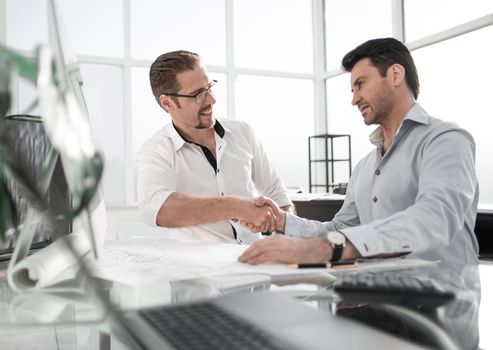 handshake Manager and client near the table. the concept of cooperation