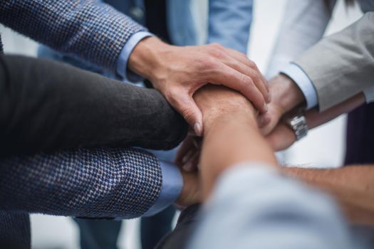 close up.business team putting their hands together. the concept of unity