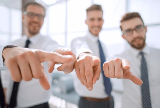 background image of a successful business team pointing to you.photo with text space