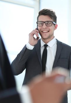 businessmen use smartphones in the office. a big plan.