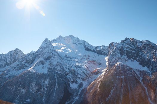 Dombay, alps, snow-covered slopes, the first snow in the mountains, sun and good weather, winter ski season High quality photo about