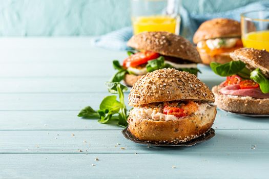 Sandwiche with crab salad and shrimp, multigrain bun on blue wooden background. Healthy lunch concept with copy space