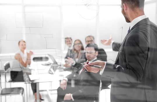 Focused caucasian business people meeting in boardroom behind glass.