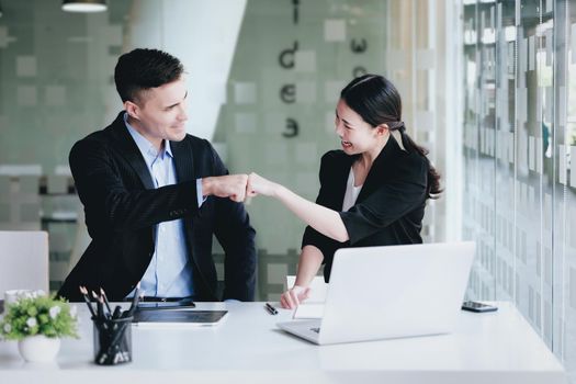 Business Success concept with partner, Partnership Giving Fist Bump after Complete a deal. Successful Teamwork, Businessman with Team Agreement in Corporate