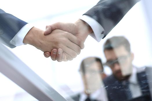 handshake business colleagues in office