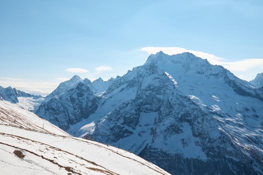 High quality photo about Dombay, alps, snow-covered slopes, the first snow in the mountains, sun and good weather, winter ski season