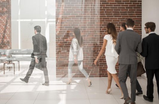 employees walking through the office hall.business concept