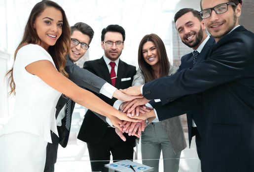 happy business team joining hands together. start-up