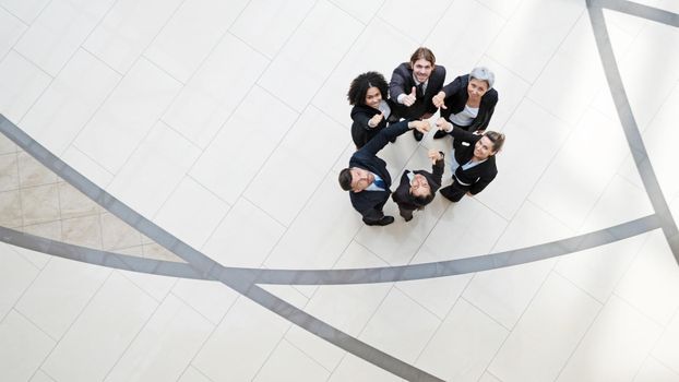 Top view of business people with thumbs up together in a circle