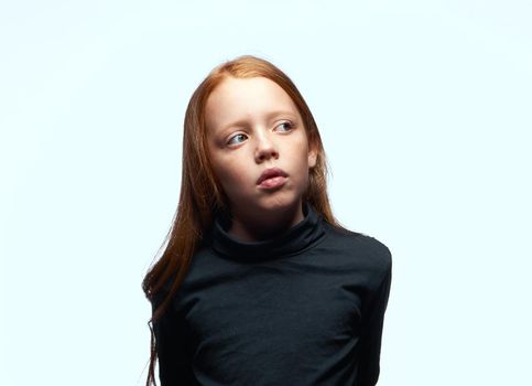 red-haired girl in a black sweater planning close-up. High quality photo