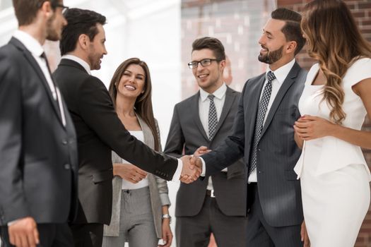 smiling business people shaking hands with each other.the concept of cooperation