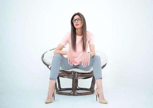modern young woman sitting in a round chair.photo with copy space