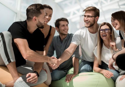 young designers shaking hands with each other . the concept of teamwork