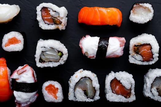 japanese sushi food. Maki ands rolls with tuna, salmon, shrimp, crab and avocado. Top view of assorted sushi