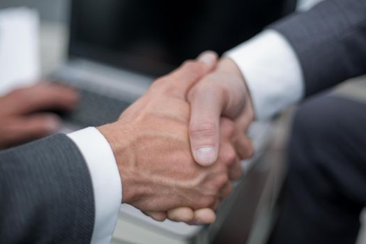 close up. handshake business partners.the concept of cooperation