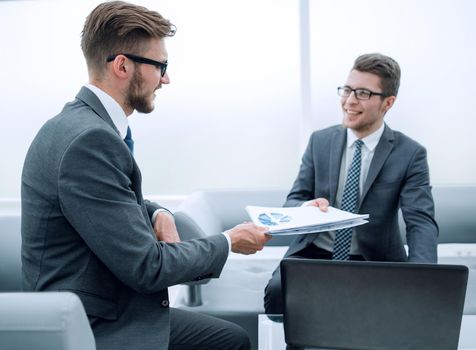 businessman giving a colleague the financial documents.business concept